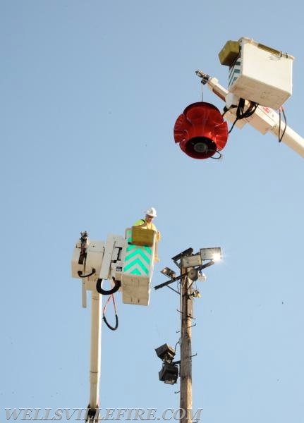 Re-conditioned siren placed back on pole, 07/20/16.  photos by Curt Werner